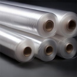 Several rolls of clear polyethylene tubing stacked together, their kraft cores facing the camera.