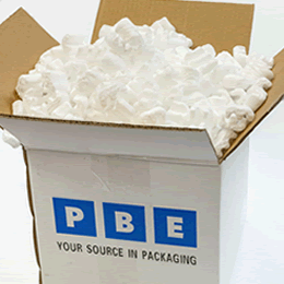 A PBE-branded carton filled with white loose fill.