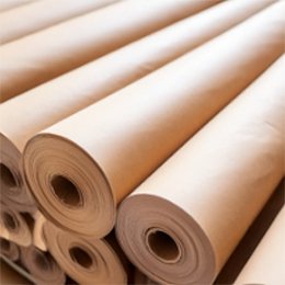 Rolls of kraft and white paper stacked on their sides, their hollow cores facing the camera.